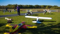 a person looking at model airplanes