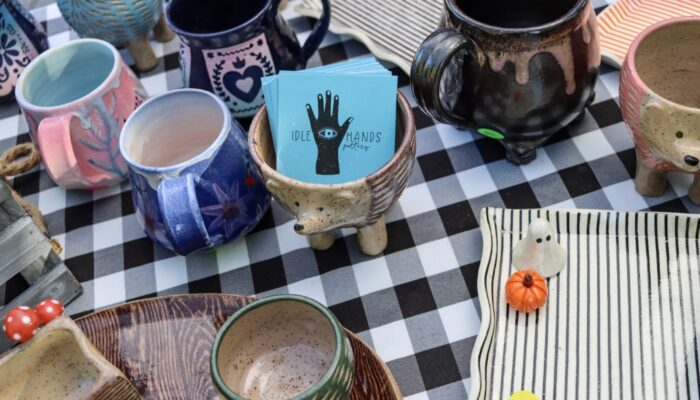 A table topped with painted pottery.